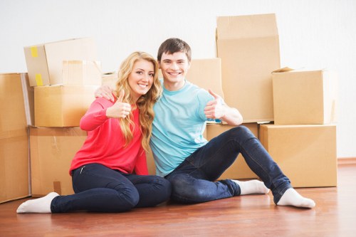 Professional movers packing fragile items for storage