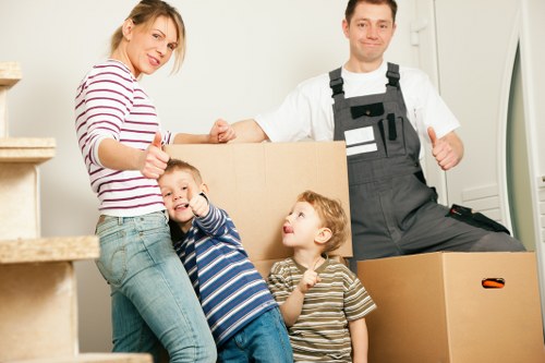 Professional movers navigating a Westbrompton street with items